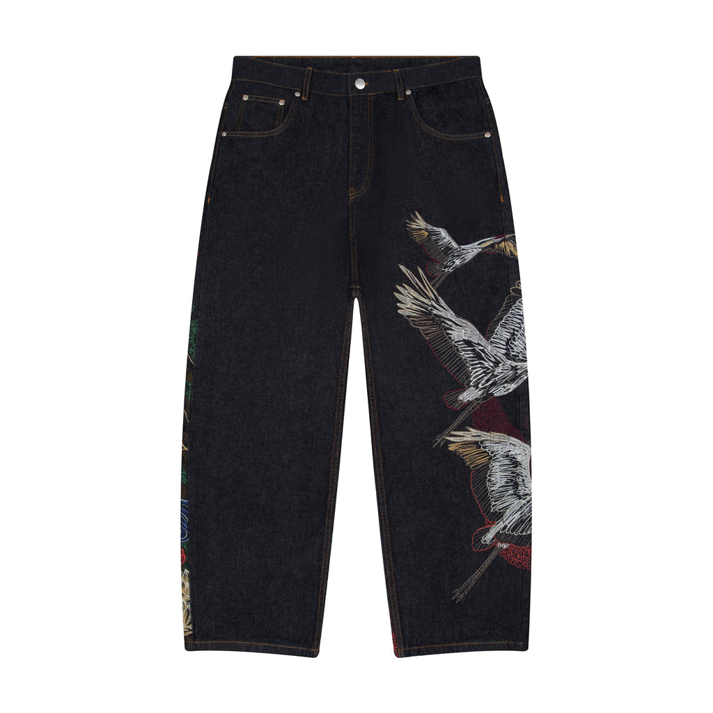 Mörka indigoblå jeans med vida ben och broderade fågel- och landskapsmotiv