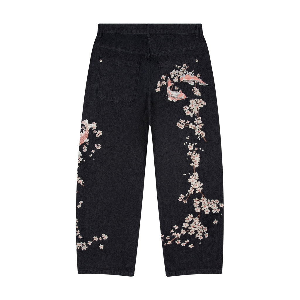 Svarta jeans med vida ben och blommiga fiskmotiv