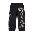 Svarta jeans med vida ben och blommiga fiskmotiv