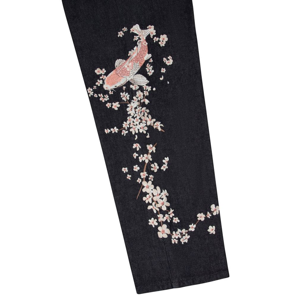Svarta jeans med vida ben och blommiga fiskmotiv