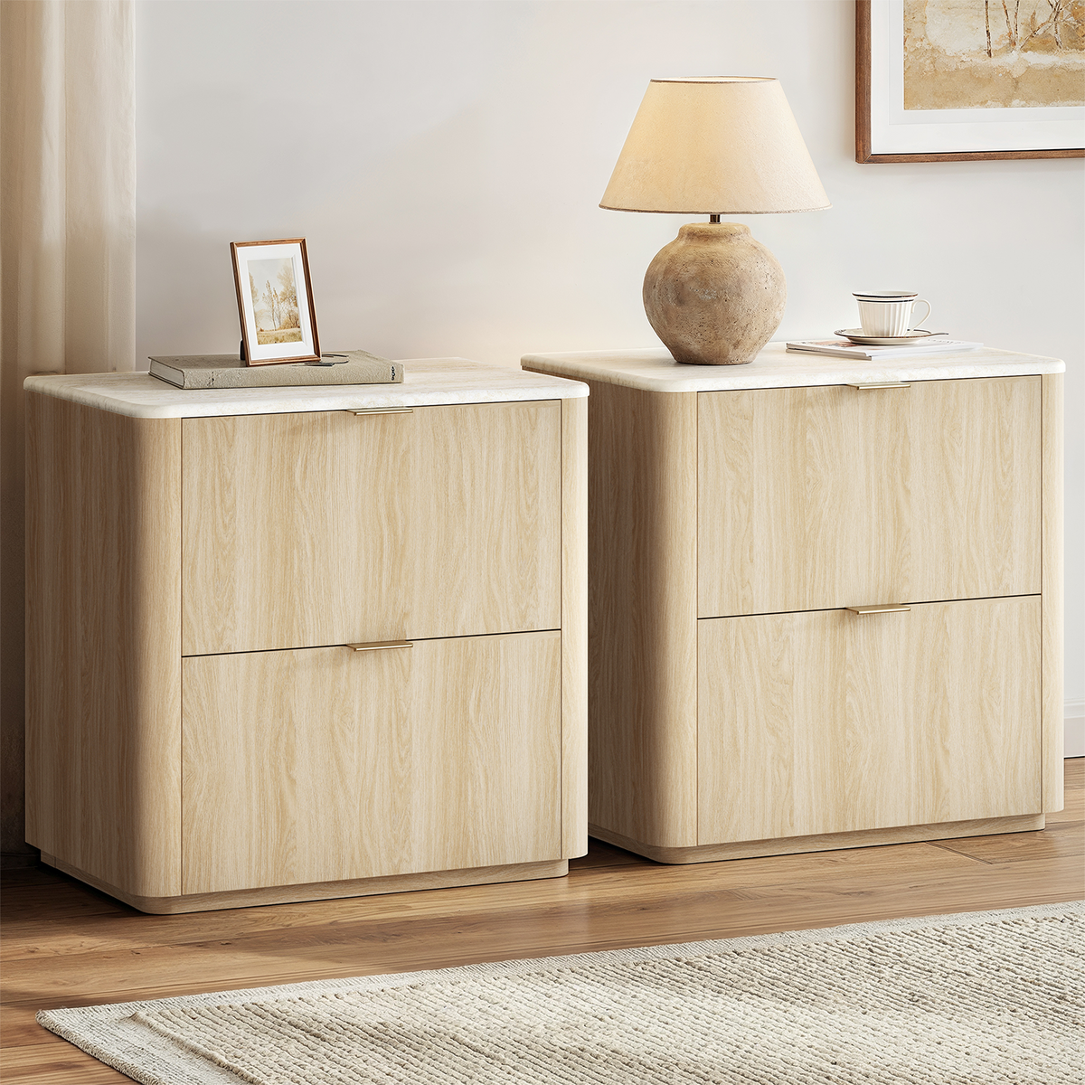 Två beige sängbord med två lådor och toppskiva i travertinlook