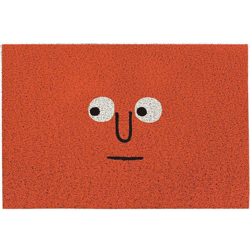 Orange dörrmatta med ansiktsmotiv och gummerad baksida
