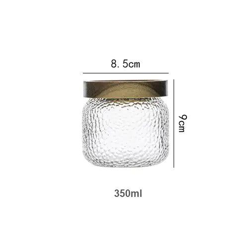 Transparent förvaringsburk i hamrat glas med mörkt trälock