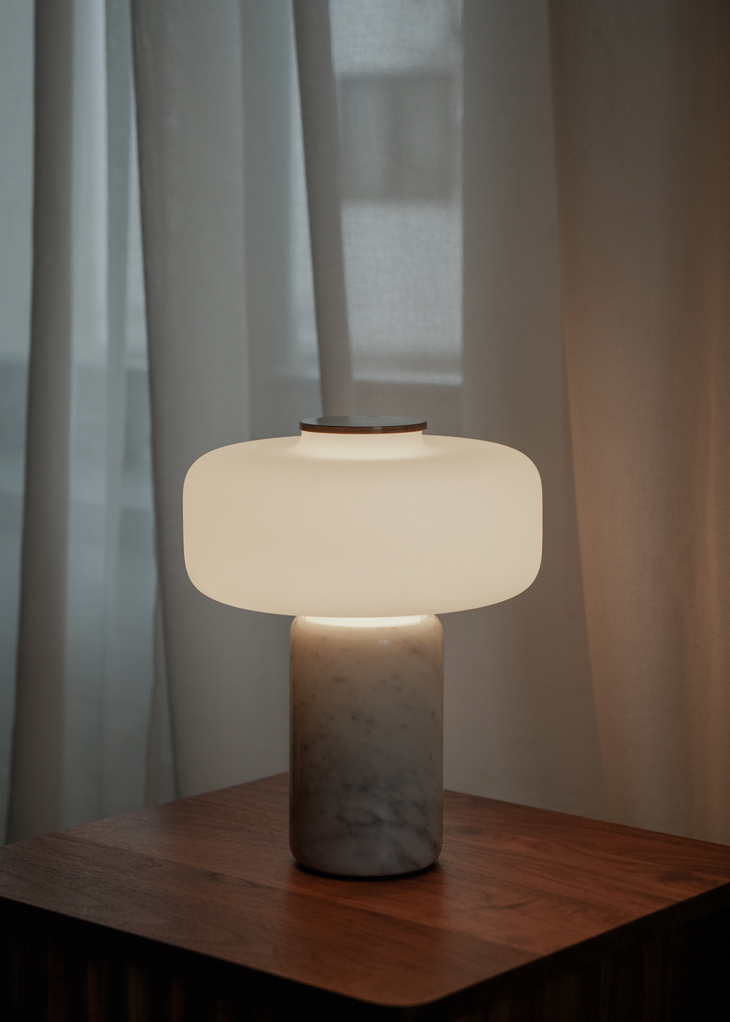 Vit bordslampa med rundad skärm, marmorerad fot och guldfärgad detalj