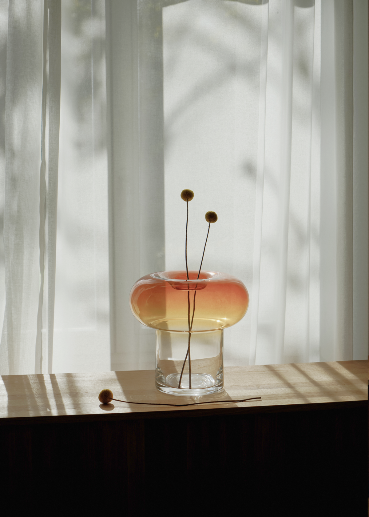 Glasvas med bärnstensfärgad rundad överdel och klar cylindrisk bas