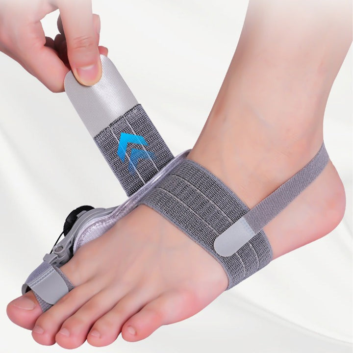 Grått hallux valgus-stöd med fotrem, tårem och vridbar justering
