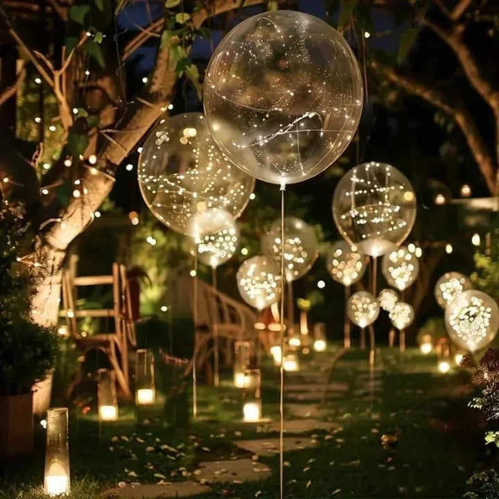 Transparenta ballonger med varm ljusdekoration i set om 10